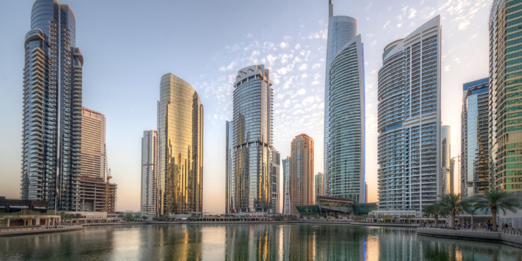 Nighttime exterior view of Marriott Residences JLT, illuminated and standing tall in Dubai's skyline.