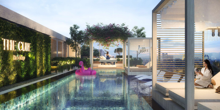 Sparkling outdoor swimming pool with city views at The Cube Residences.