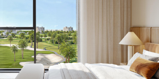 Bright bedroom in Golf Edge Apartments with floor-to-ceiling windows.