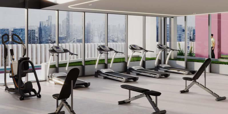 Fully equipped fitness gym at Lucky Oasis Residence with pool views