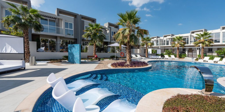 Swimming pool surrounded by lush greenery at Royal Park Villas.